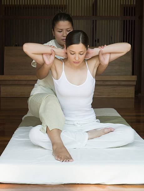 Young woman having a thai massage  thai ethnicity stock pictures, royalty-free photos & images