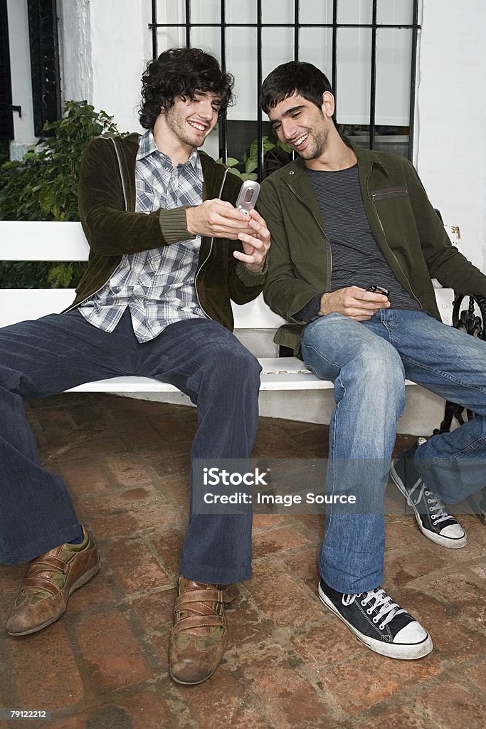 Man showing friend his phone  Adult Stock Photo