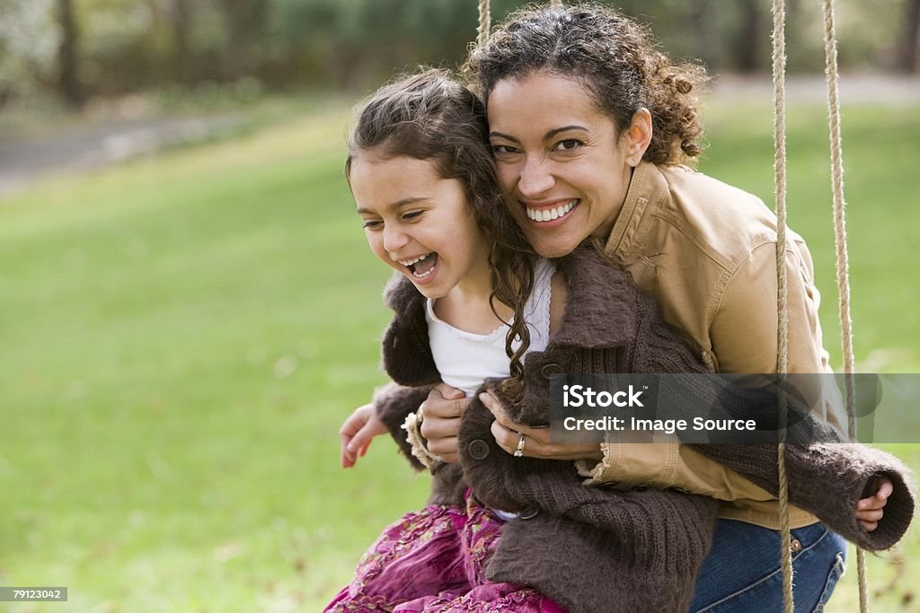Mother and daughter on swing  Family Stock Photo