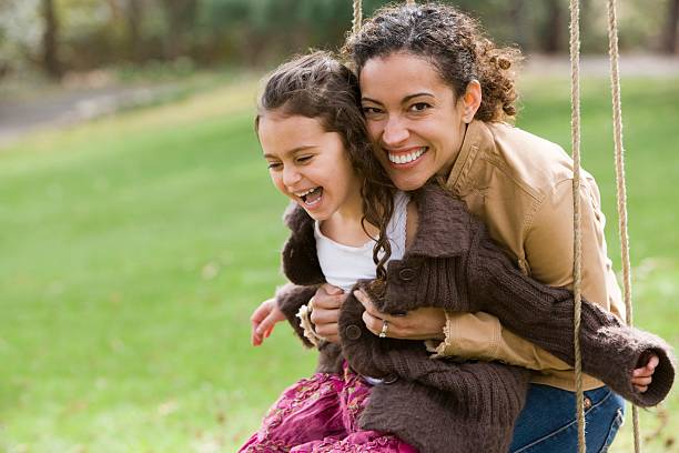 Mother and daughter on swing  one parent stock pictures, royalty-free photos & images