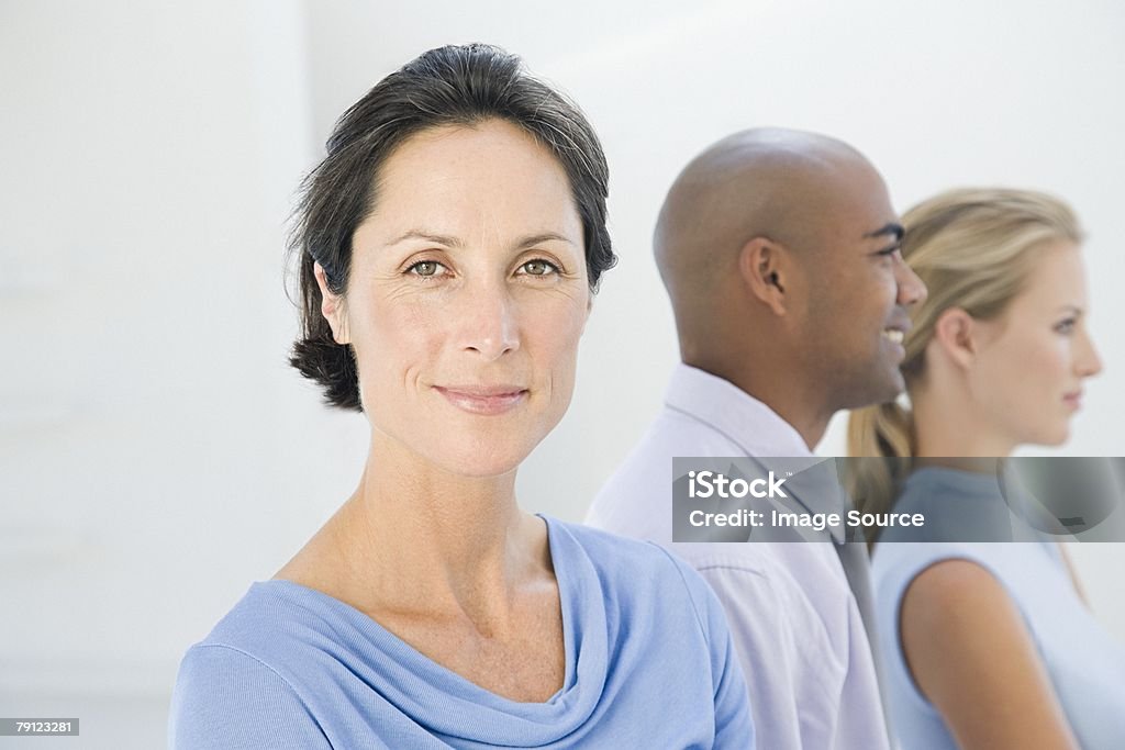 Woman and colleagues  30-39 Years Stock Photo