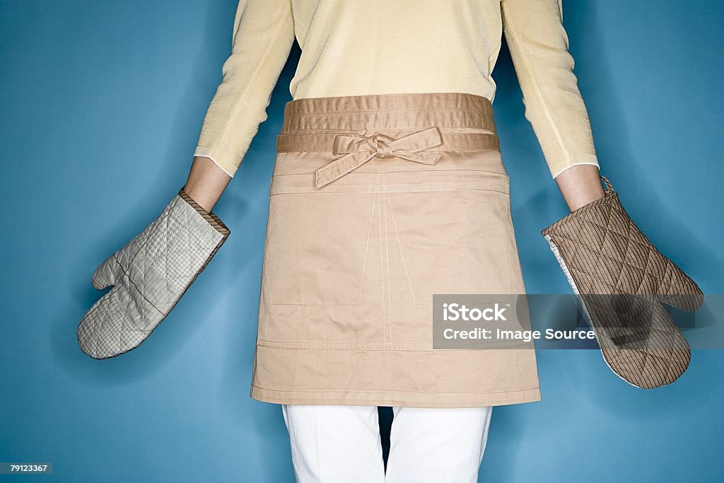 Woman wearing oven gloves  Cut Out Stock Photo