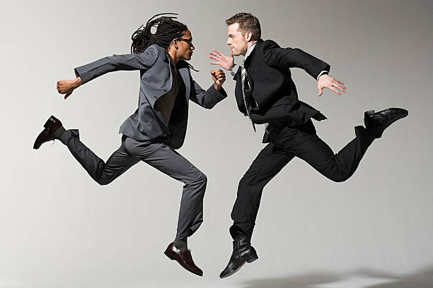 two businessmen jumping - skill side view jumping mid air 뉴스 사진 이미지