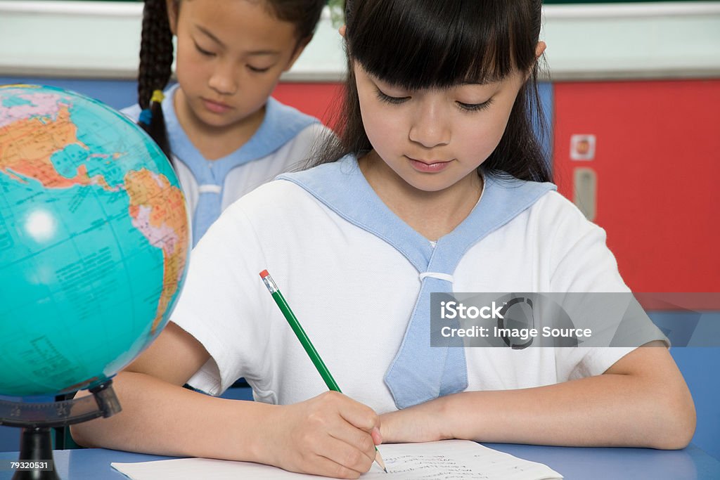 A girl writing  Child Stock Photo