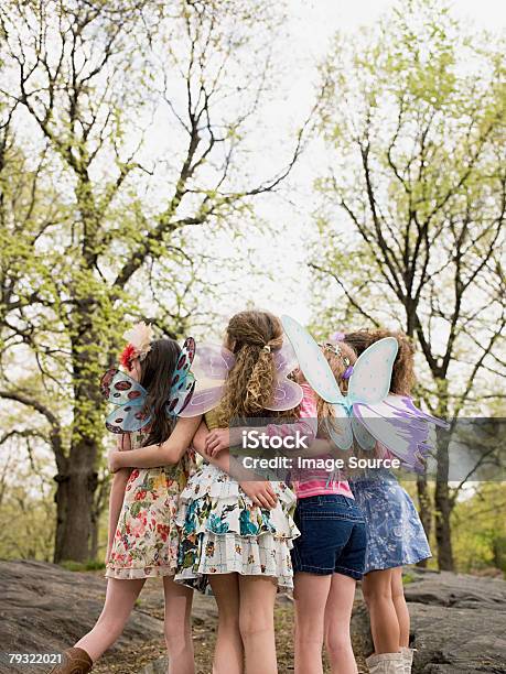 Rear View Of A Girls On A Rock Stock Photo - Download Image Now - Animal Body Part, Animal Wing, Arm Around