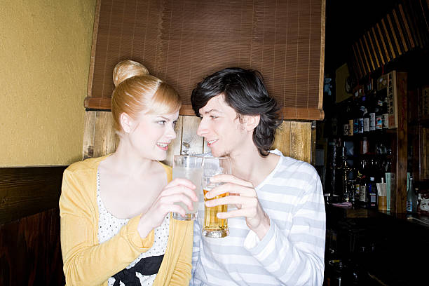 una giovane coppia brindando - glasses women smiling human face foto e immagini stock