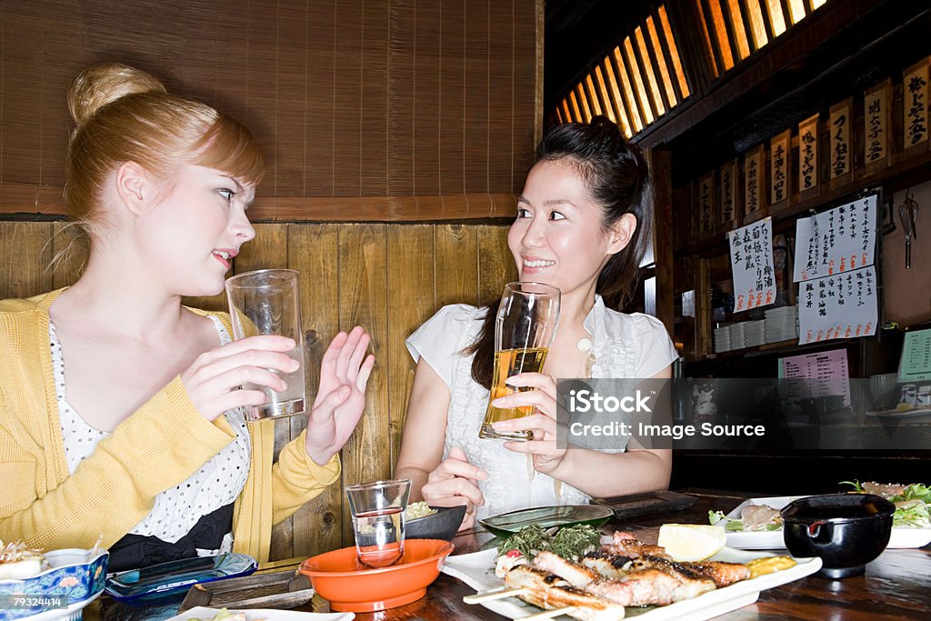 Friends talking in a bar  Yakitori Stock Photo