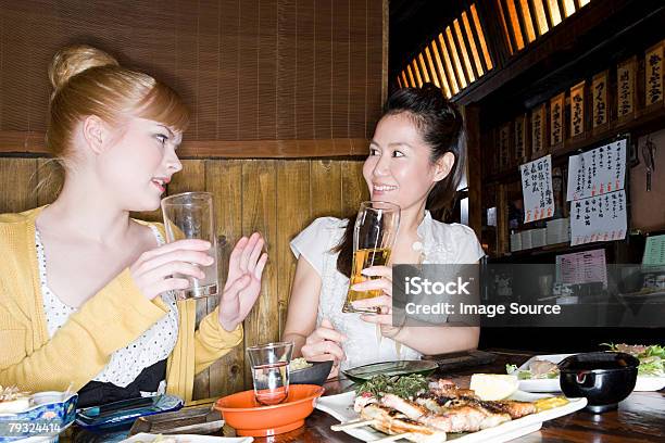 Friends Talking In A Bar Stock Photo - Download Image Now - Yakitori, Adult, Adults Only