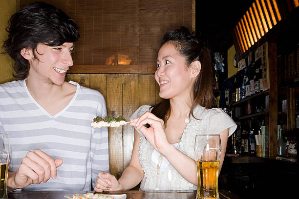 una coppia avendo yakitori - glasses women smiling human face foto e immagini stock