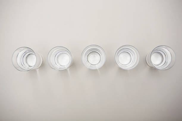 glasses of mineral water in a row - shot on white foto e immagini stock