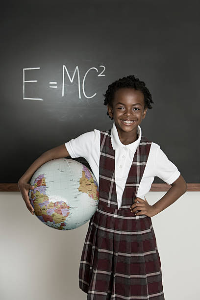 девушка с globe - science child african ethnicity elementary student стоковые фото и изображения