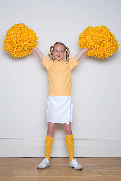 Cheerleader With Yellow Pom Poms Stock Photo - Download Image Now -  Cheerleader, Full Length, Studio Shot - iStock