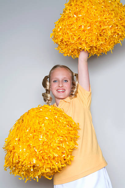 Cheerleader With Yellow Pom Poms Stock Photo - Download Image Now -  Pom-Pom, Yellow, Cheerleader - iStock