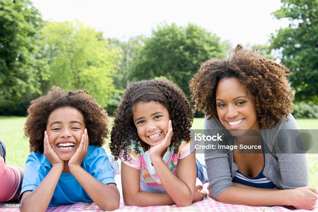 Mother and children in park  Child Stock Photo