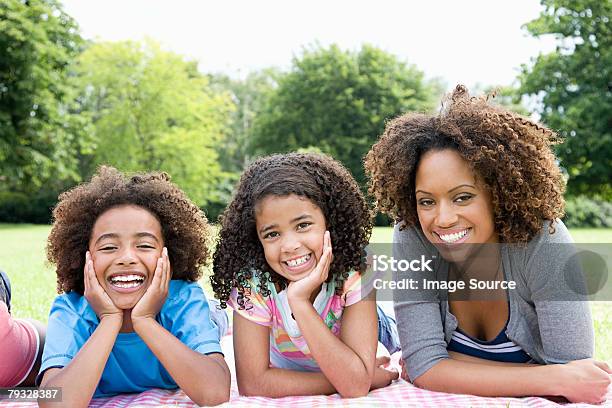 Mother And Children In Park Stock Photo - Download Image Now - Child, Curly Hair, Mother
