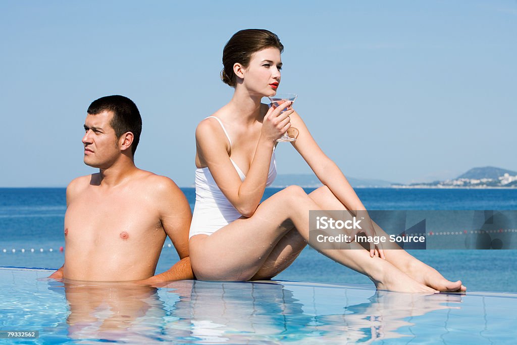 Glamorous couple in pool  Cocktail Stock Photo