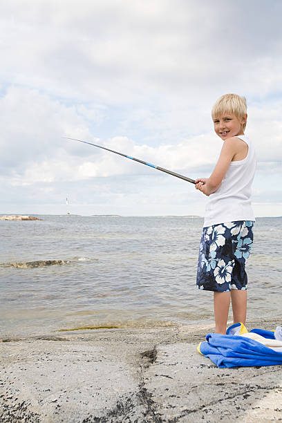 un garçon de pêche - sweden fishing child little boys photos et images de collection