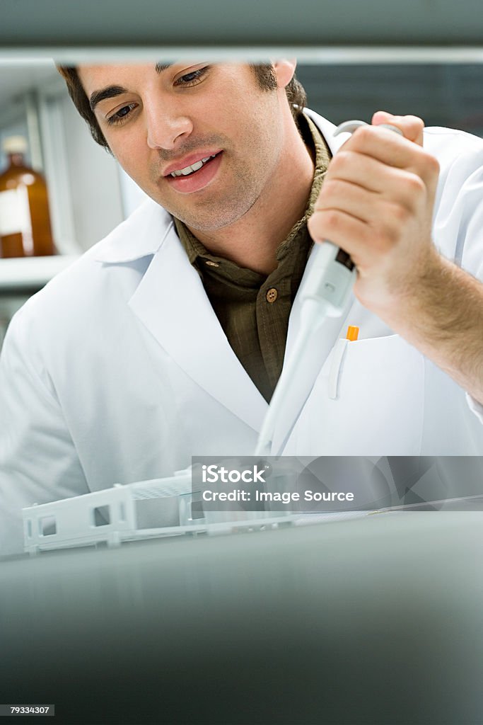 A scientist using a pipette  20-29 Years Stock Photo