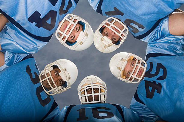 American football players in huddle  safety american football player stock pictures, royalty-free photos & images