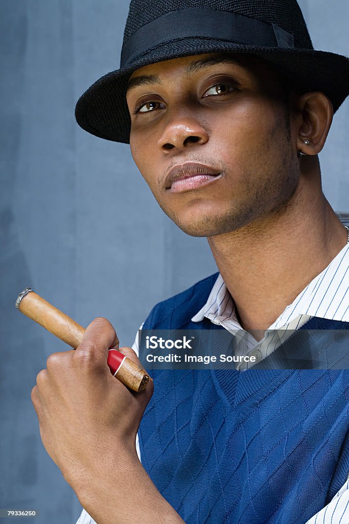 Young man having a cigar  20-29 Years Stock Photo