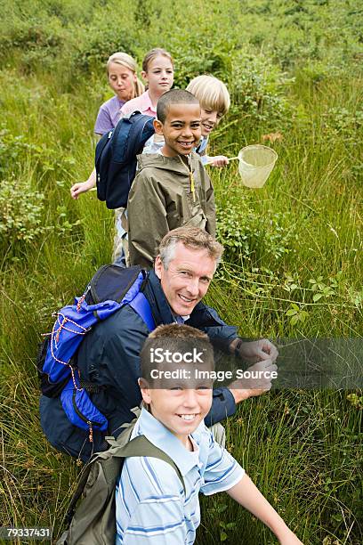Teacher And Pupils At Nature Reserve Stock Photo - Download Image Now - Nature, Education, School Building