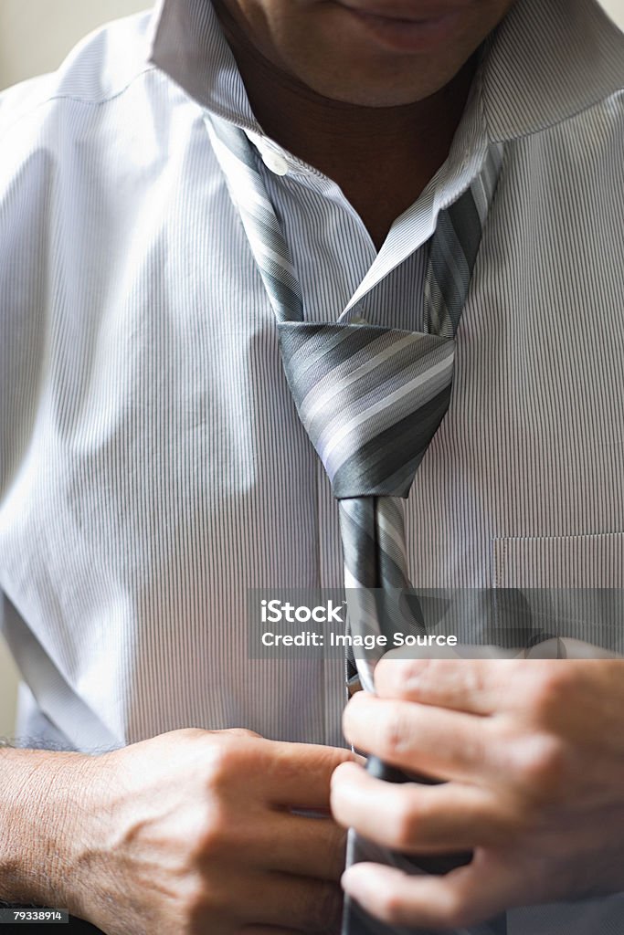 Man tying tie  Adult Stock Photo