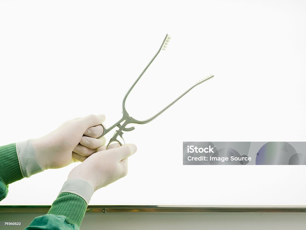 A surgeon holding surgical clamps  Clamp Stock Photo