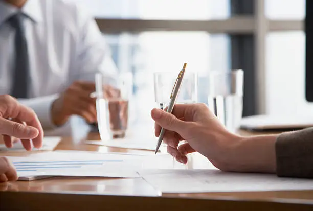 Photo of Three businesspeople at a boardroom table