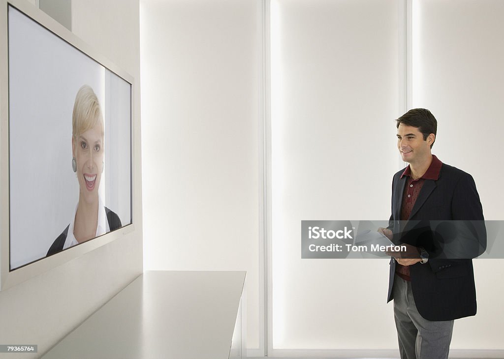 Businessman and businesswoman having a video conference  Board Room Stock Photo