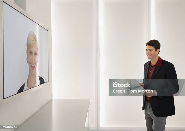 Businessman And Businesswoman Having A Video Conference Stock Photo - Download Image Now