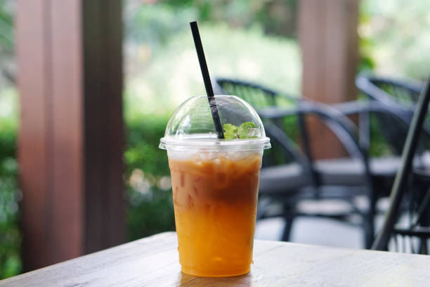 istock Iced tea with lemon and orange in plastic glass on wooden table. 800000312