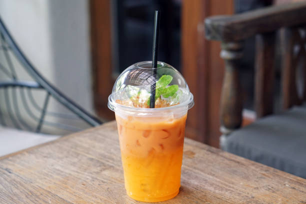 istock Iced tea with lemon and orange in plastic glass on wooden table. 800000336