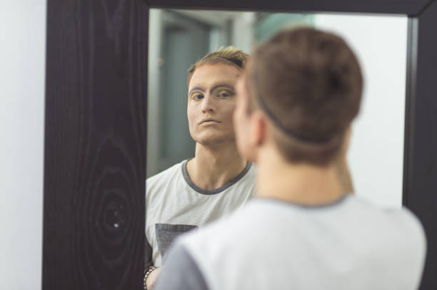 istock Man gets dressed in drag attire in bathroom 800160468