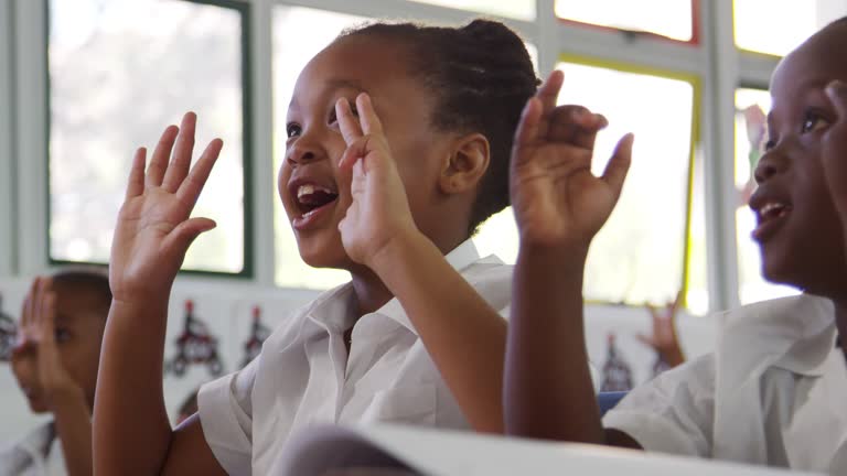 School kids counting with fingers at an elementary school