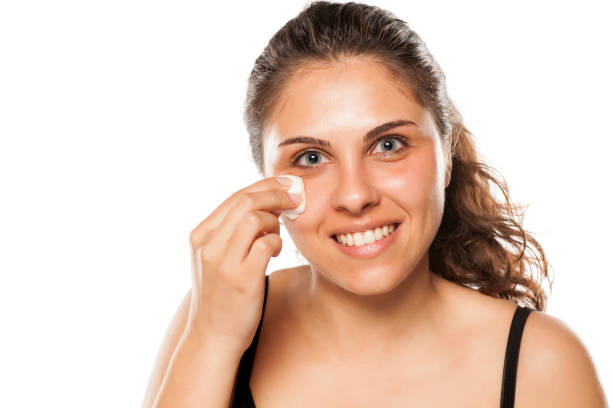istock young woman cleans her face using tonic and cotton pads 800178560
