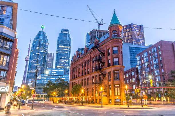 Gooderham Building in Toronto Gooderham Building in Toronto with CN Tower in the Background flatiron building toronto stock pictures, royalty-free photos & images