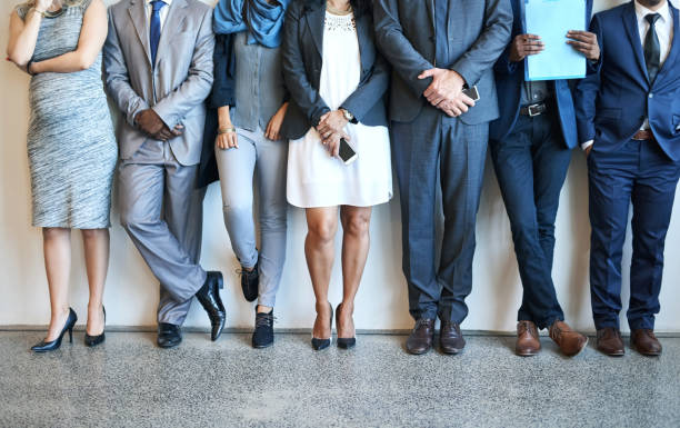 Putting their best foot forward Cropped shot of a group of unidentifiable businesspeople standing in line while waiting to be interviewed hire job search job people stock pictures, royalty-free photos & images