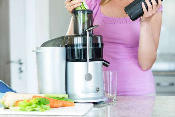 istock Woman preparing a smoothie in the kitchen 800289892