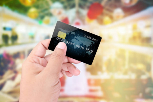 istock Hand holding credit card on blurred abstract background 800293472