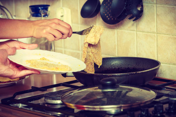 istock Human frying breaded chicken cutlet. 800294172