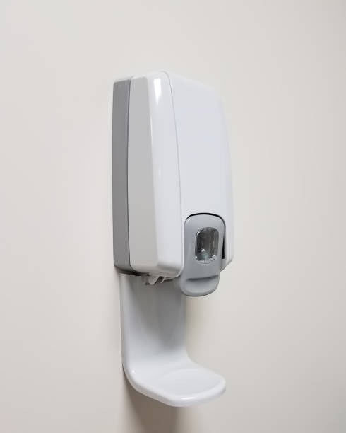 istock Hand sanitizer dispenser on a white wall 800296868