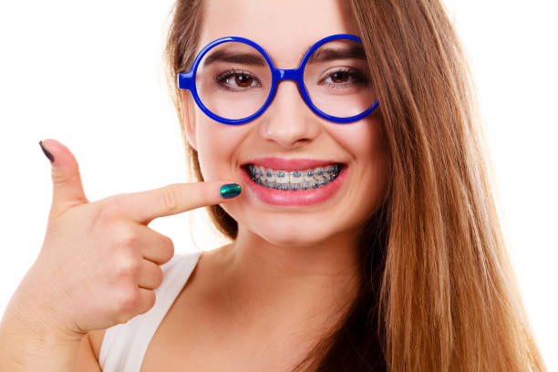 istock Nerdy woman showing her teeth with braces 800300498