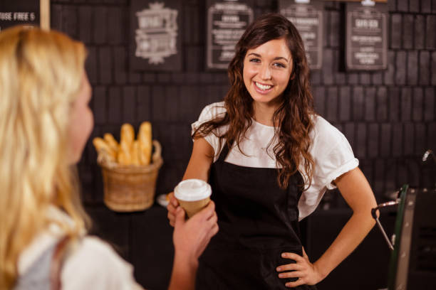 istock Pretty waitress giving cup of coffee to customer 800302190