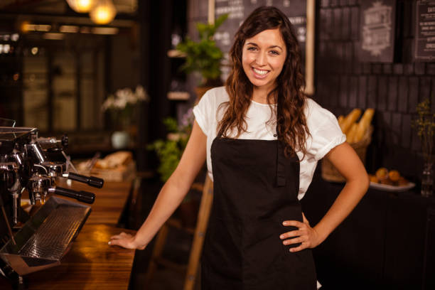 istock Pretty waitress posing next to coffee machine 800302670
