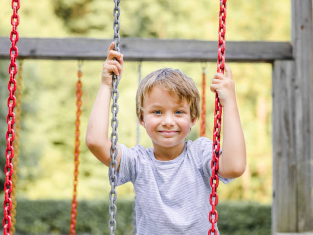 istock Child, boy playing at a children‘s playground 800303444