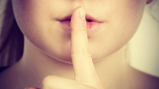istock Woman showing silence gesture with finger 800309554