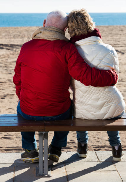 istock Mature couple sitting by sea 800313444