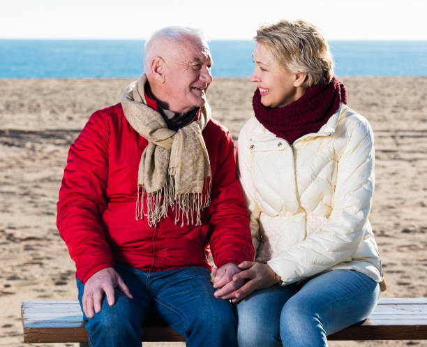 istock Mature couple sitting by sea 800313446