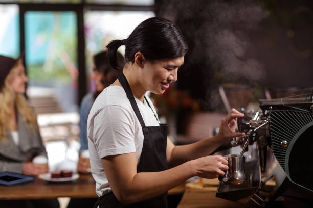 istock Smiling waiter making cup of coffee 800316668