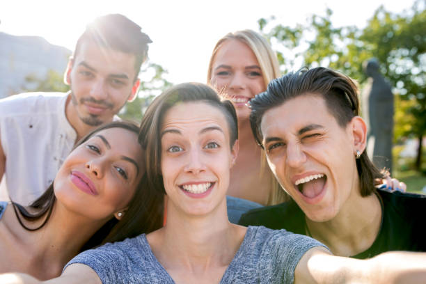 istock Playful friends taking selfie outdoors. 800319522